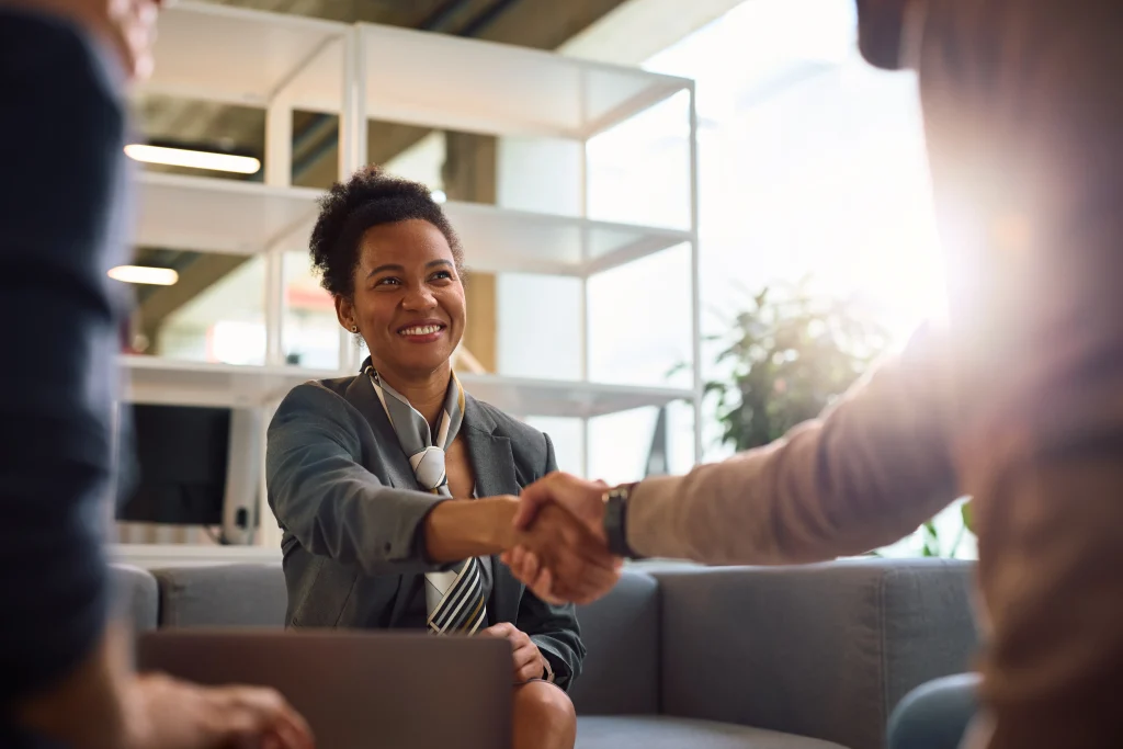 Client receives a certificate of insurance as they shake hands with their insurance agent