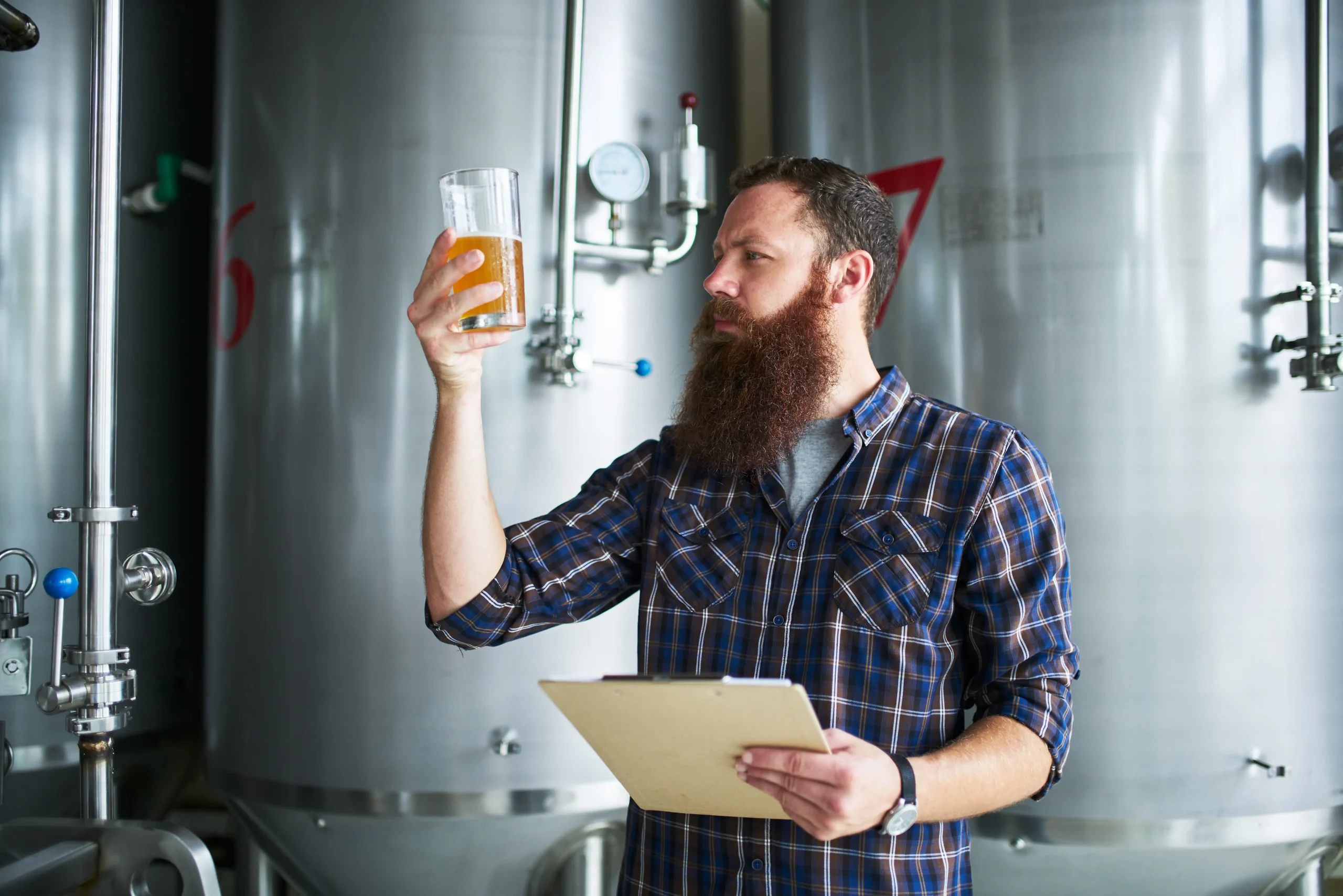worker covered by brewery insurance tasting product