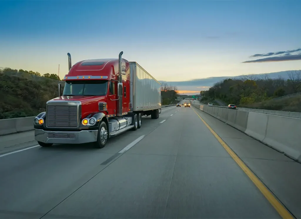 Business-Insurance-A-Red-Truck-Driving-Down-the-Highway-Late-in-the-Afternoon
