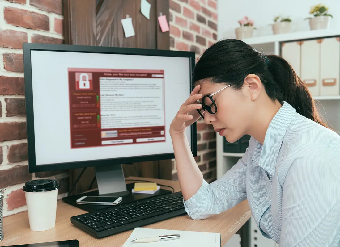 Home-Cyber-Insurance-Woman-Stressed-While-Sitting-at-Her-Home-Office-After-Finding-Out-Her-Computer-Has-a-Virus-Attack