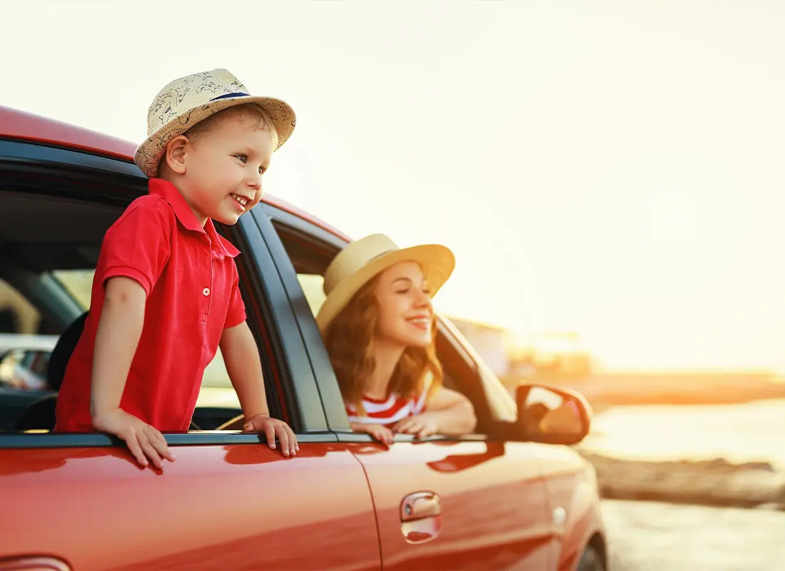 Personal-Insurance-A-Mother-and-Her-Son-Looking-Out-the-Window-at-a-Beautiful-Sunset-While-in-Their-Car