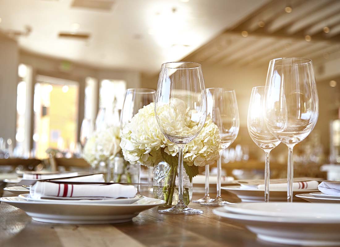 Special-Event-Insurance-Close-up-of-a-Tasteful-Table-Set-Display-of-Wine-Glasses-and-Flowers-for-an-Large-Event-or-Celebration